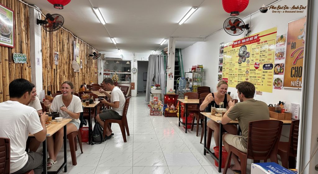 4. A moment when guests savor a steaming stone bowl of pho in a warm and cozy setting